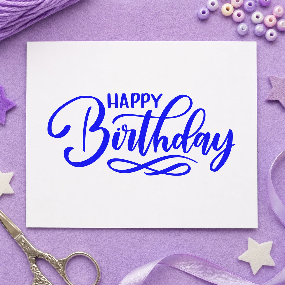 Happy Birthday Infinity Flourish craft stamp in blue ink on cardstock, an easy option for party tote printing.