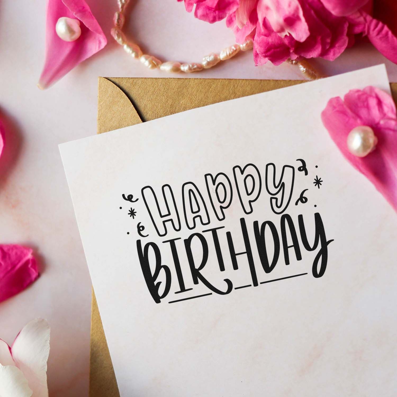Happy Birthday rubber stamp design on a greeting card with pink flowers and envelope for handmade birthday cards.