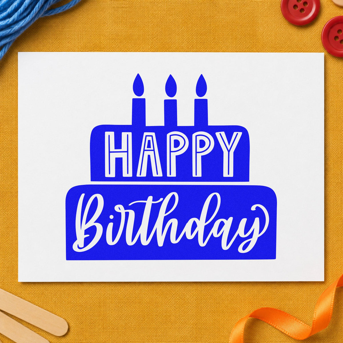 Happy Birthday Solid Cake craft stamp in blue ink on cardstock, an easy option for service apron printing.