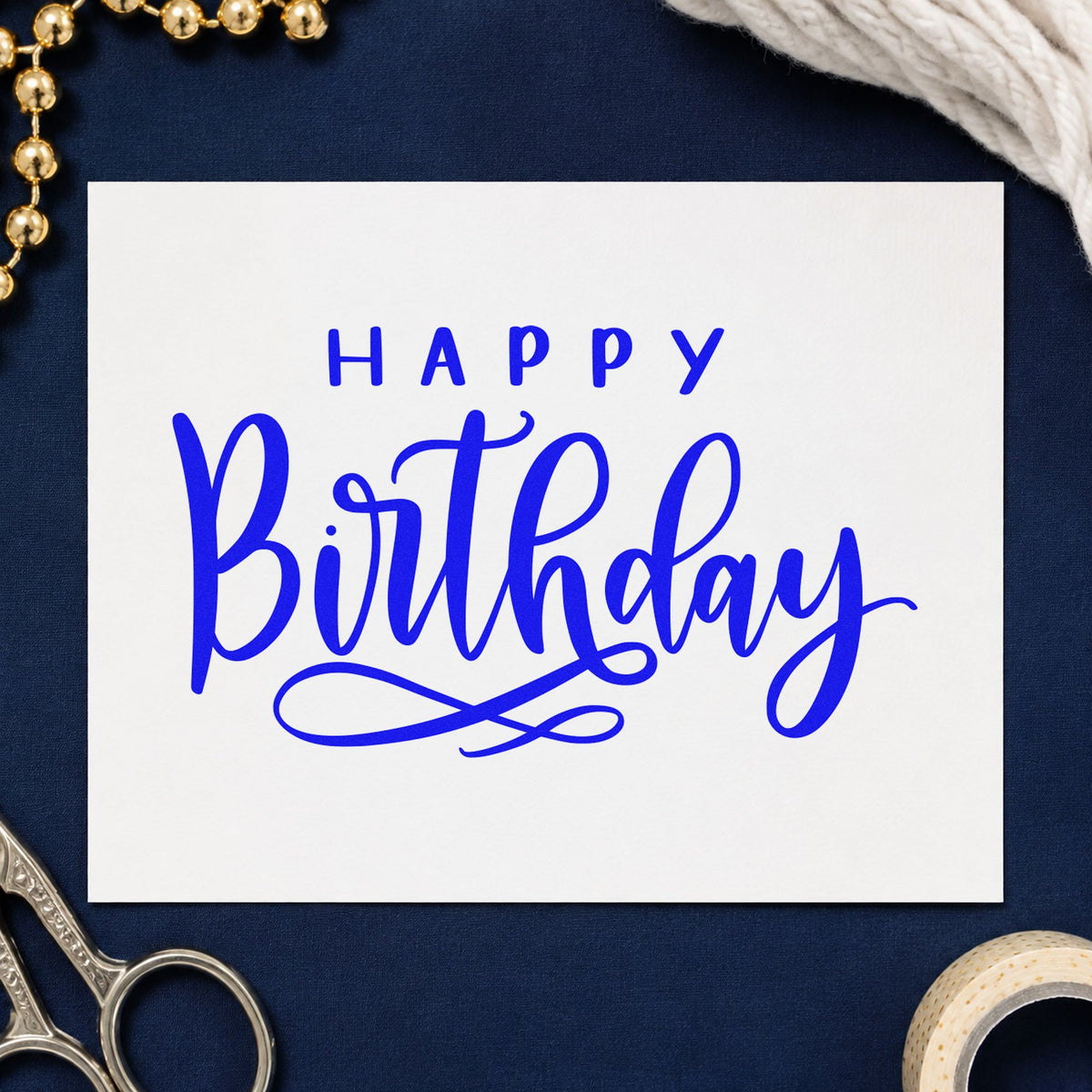 Happy Birthday Loop Underline craft stamp imprinted in blue ink on paper, a design suited to framed desk shelf.