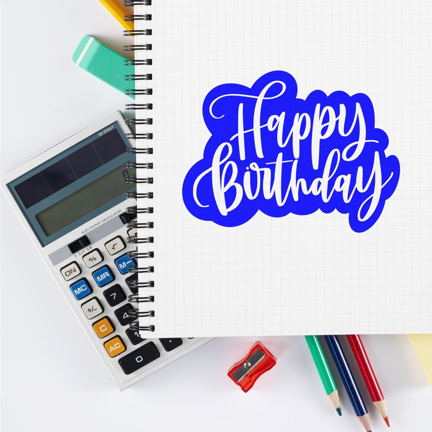 Happy Birthday rubber stamp design on notebook with calculator and pencils, perfect for custom birthday stamps.