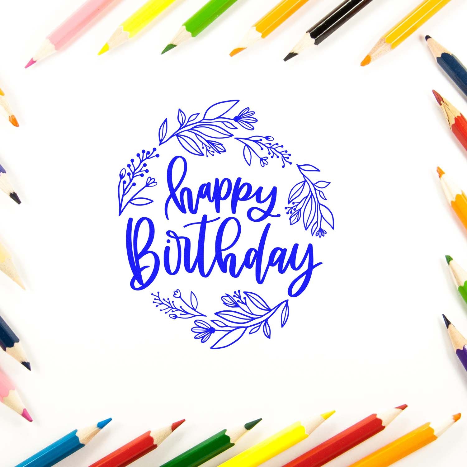 Happy Birthday floral rubber stamp design for greeting cards and crafts, surrounded by colored pencils.