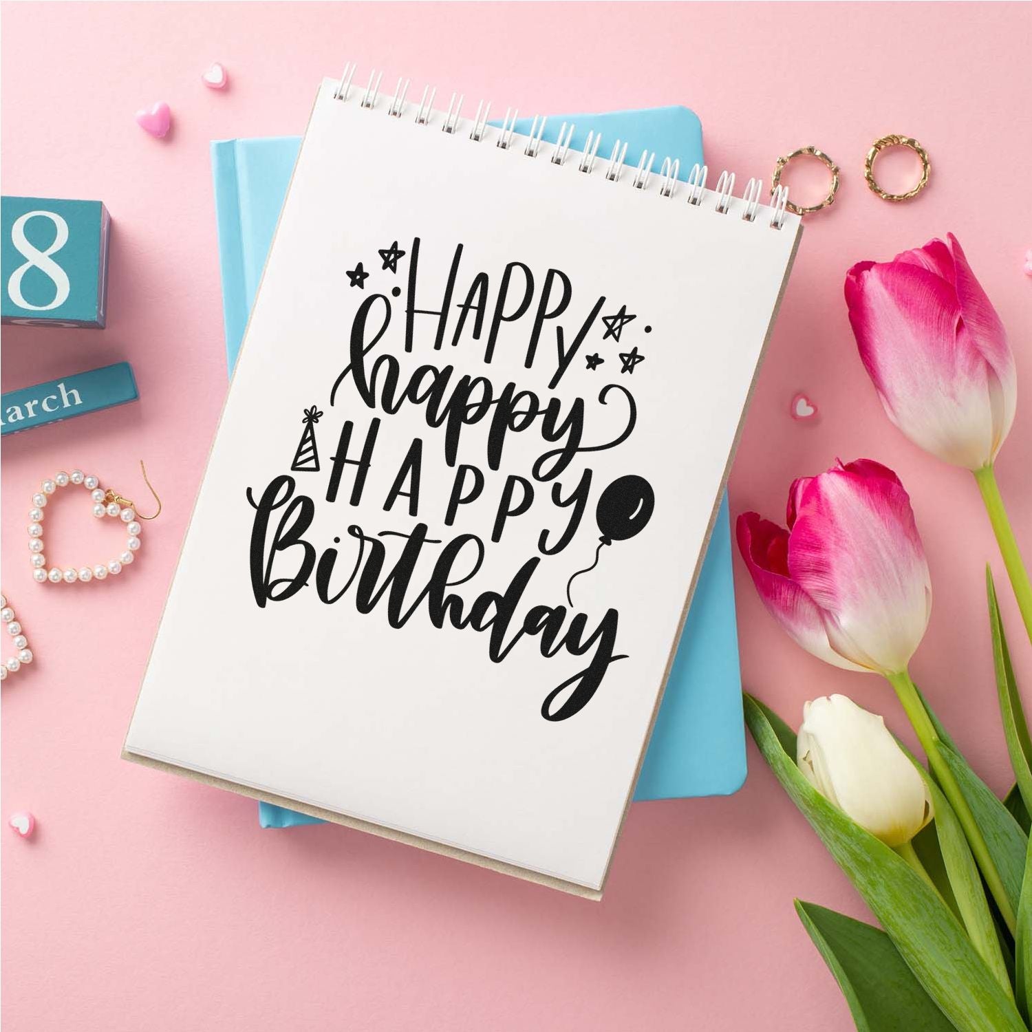 Happy Birthday rubber stamp design on notebook, perfect for handmade birthday cards, scrapbooking, and craft projects.