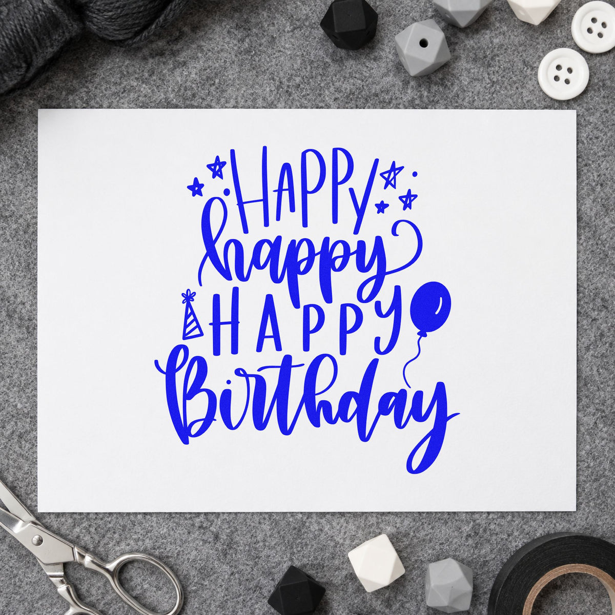 Repeated Happy Birthday Balloons craft stamp in blue ink on cardstock, an easy option for play mat printing.