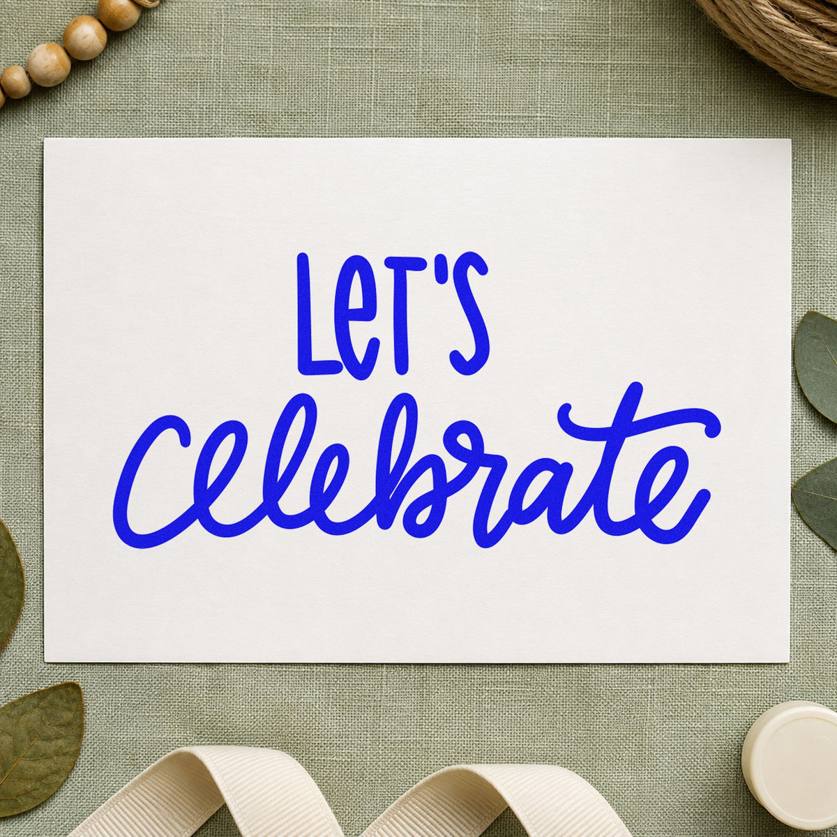 Let's Celebrate Script craft stamp imprinted in blue ink on paper, a design suited to framed front hall.