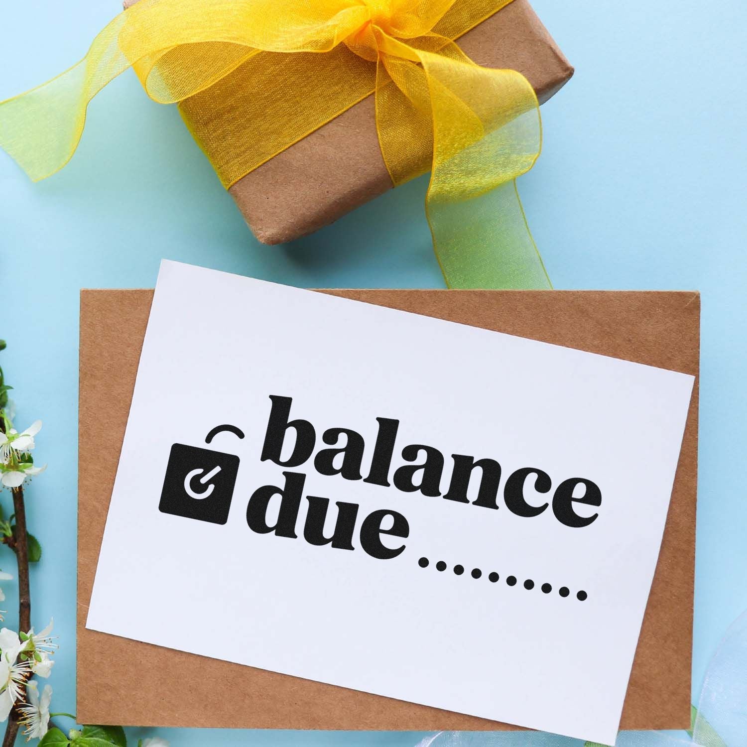 Balance due rubber stamp imprint on a gift package card for invoice reminders and small business use.
