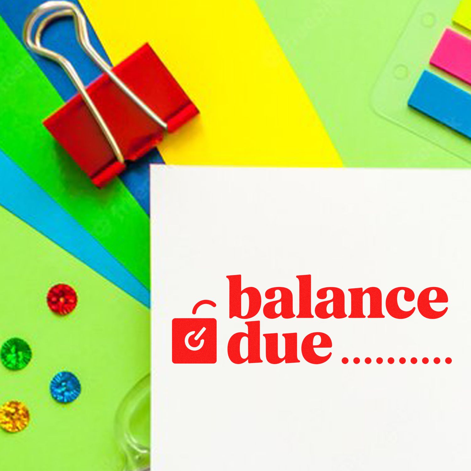 Balance due rubber stamp impression on white paper with colorful office supplies background
