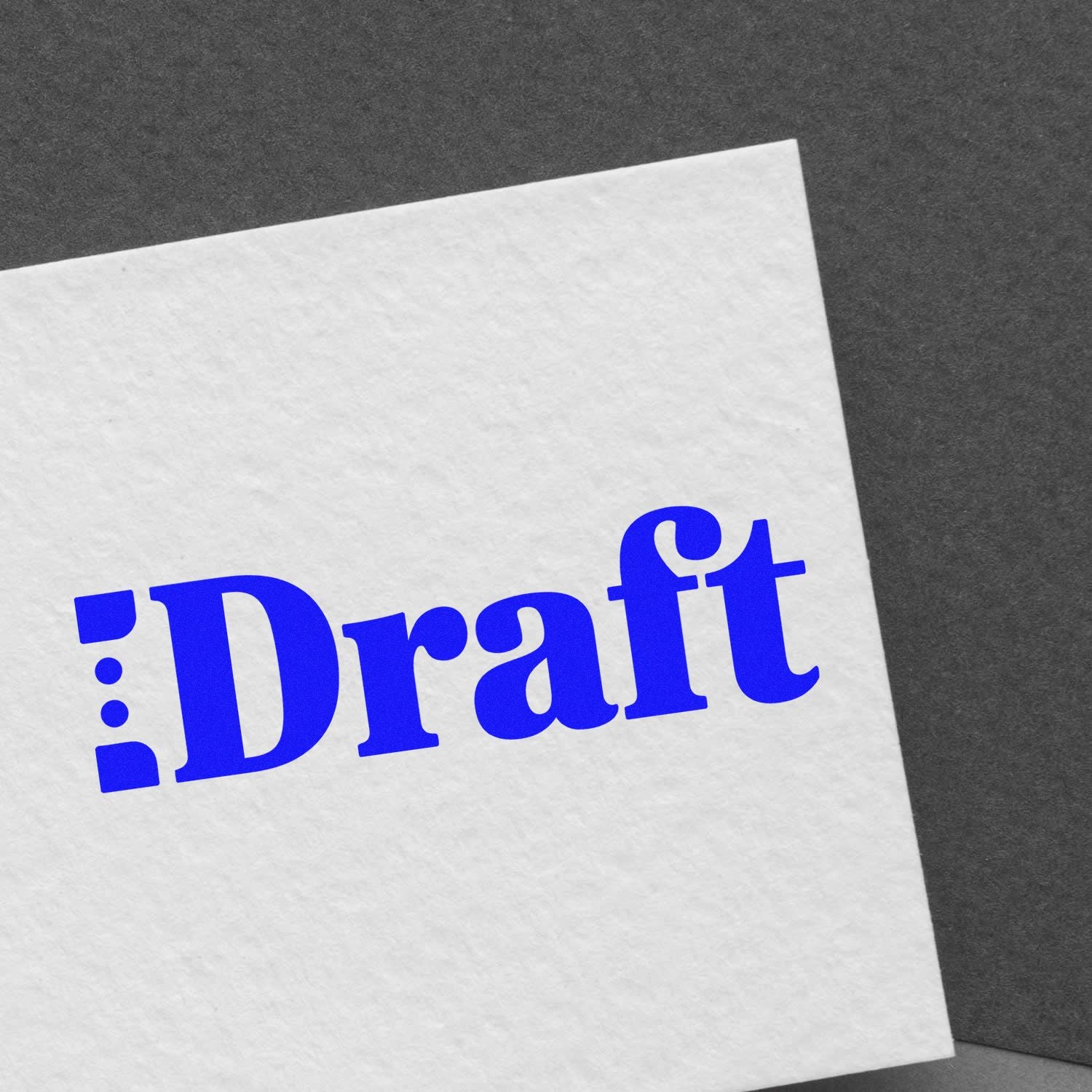 Blue Draft rubber stamp impression on white paper, marking a document as draft for review.