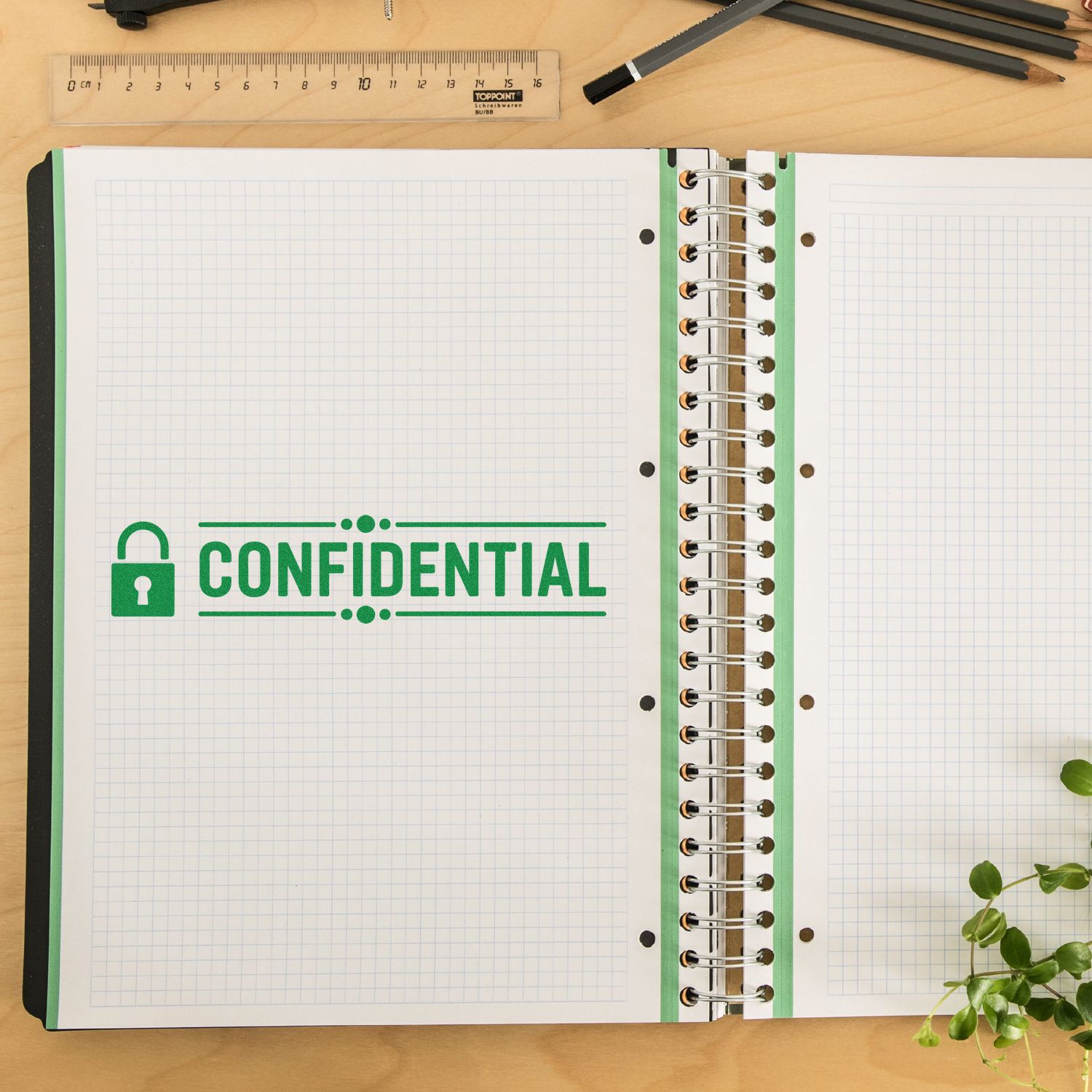 Confidential rubber stamp impression on open notebook for marking sensitive documents and office files.