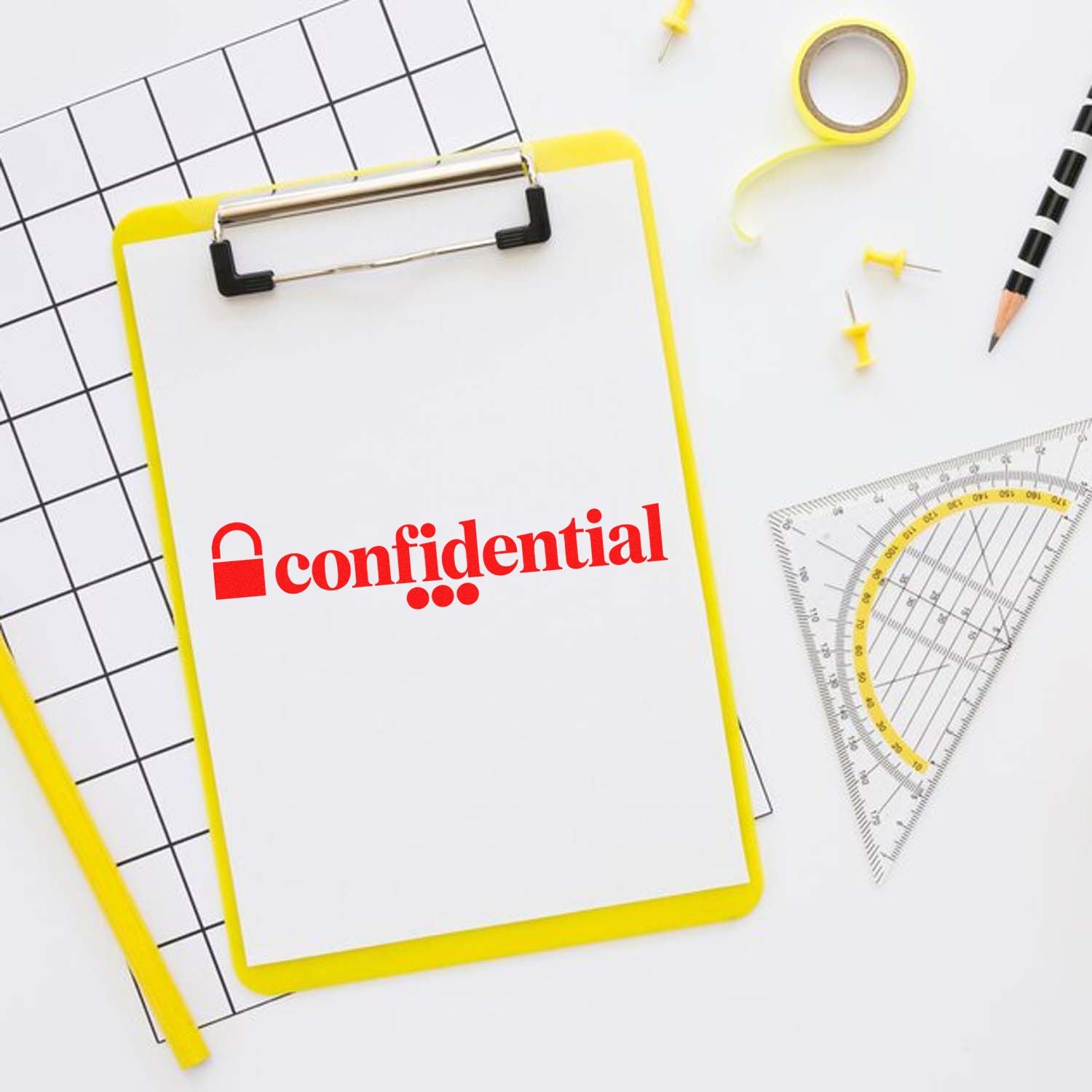 Confidential rubber stamp on clipboard with office stationery, ideal for secure document marking and filing.