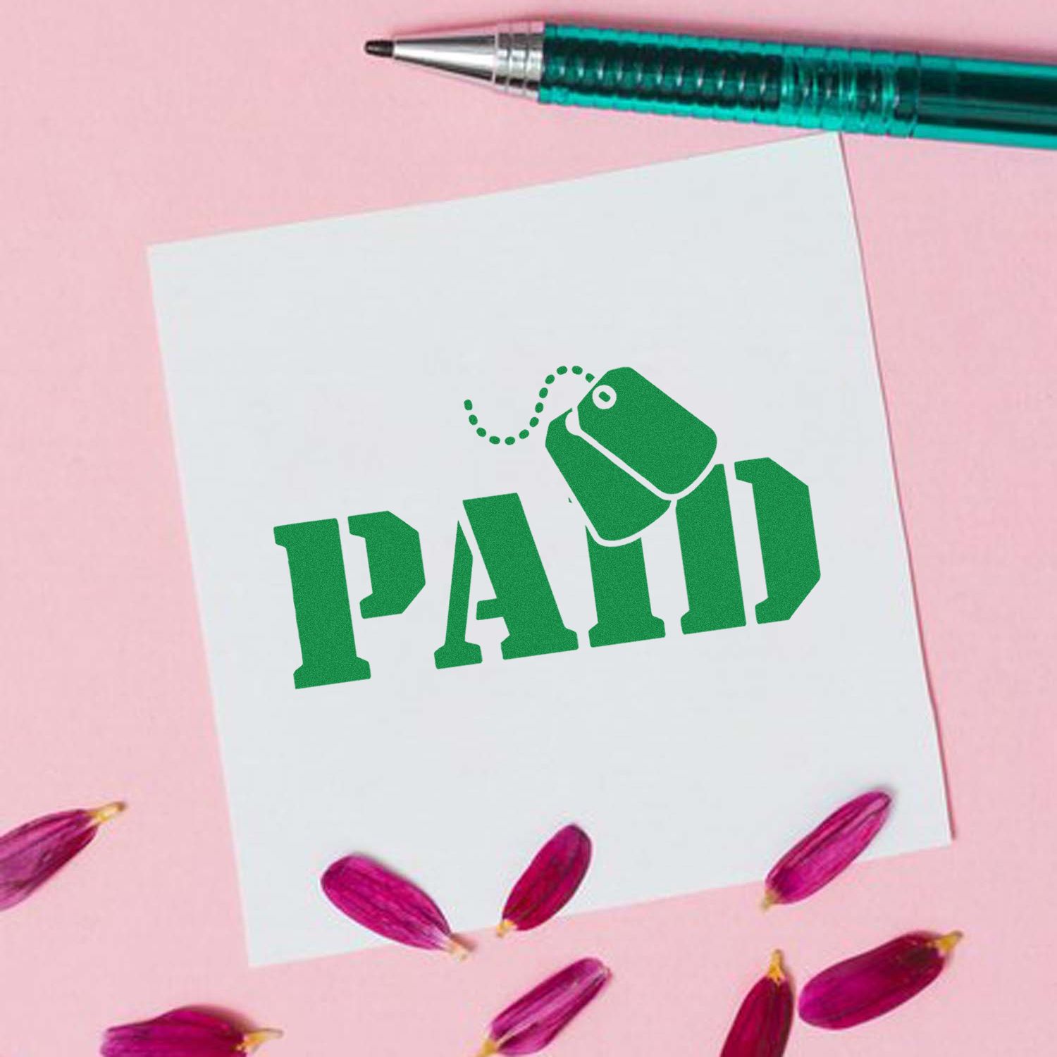 Green PAID rubber stamp on paper with pen, for invoice approval and bookkeeping.