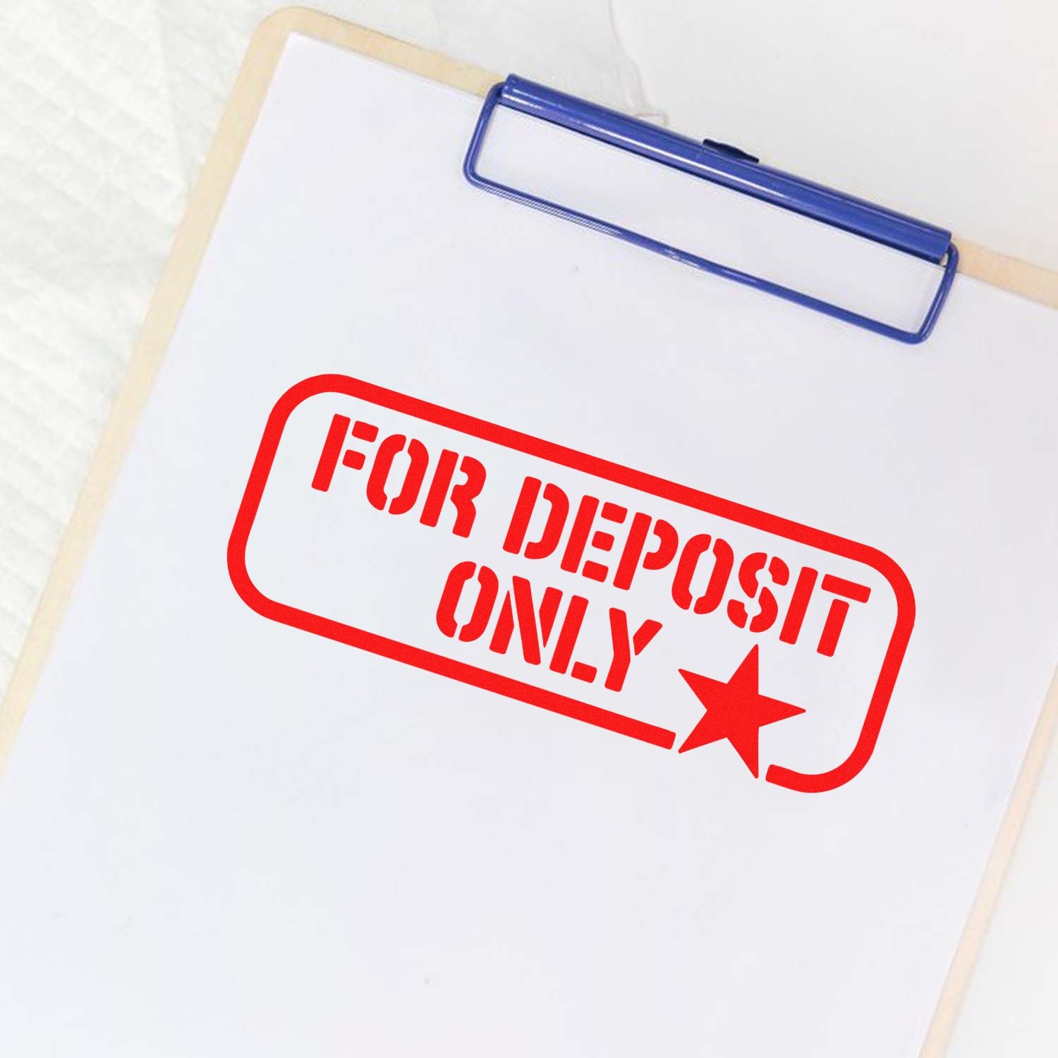 Red FOR DEPOSIT ONLY rubber stamp on clipboard for banking, check endorsement, and secure business deposits.