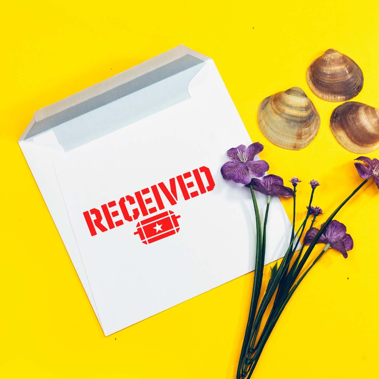 Red Received rubber stamp on white envelope, styled with flowers and seashells on a bright yellow background.