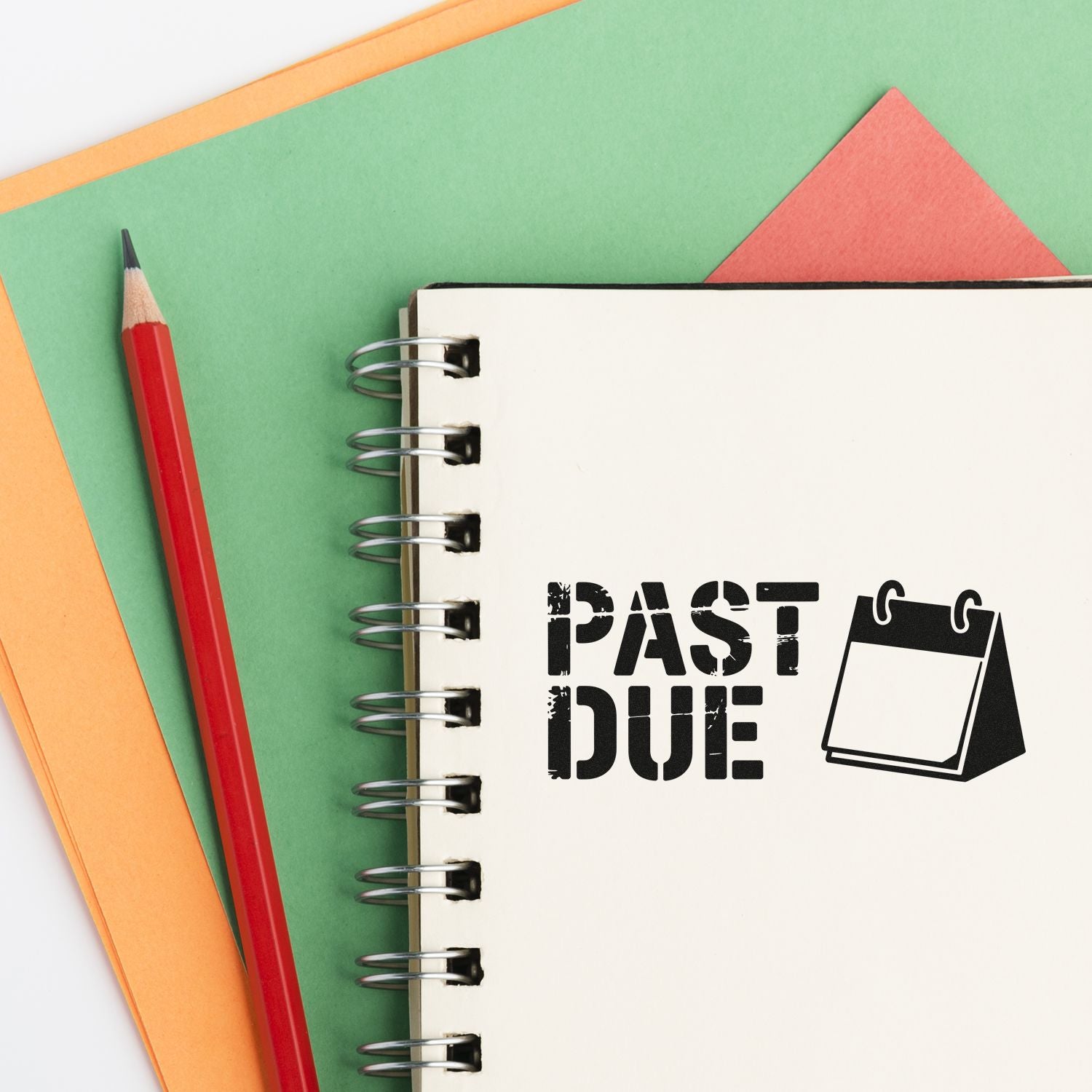 Past due rubber stamp on a spiral notebook, ideal for overdue notices, billing reminders, and office paperwork.