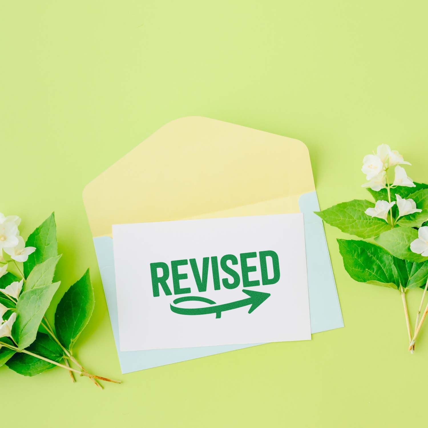 Revised rubber stamp on stationery envelope, ideal for office document updates, approval, and correction workflows.