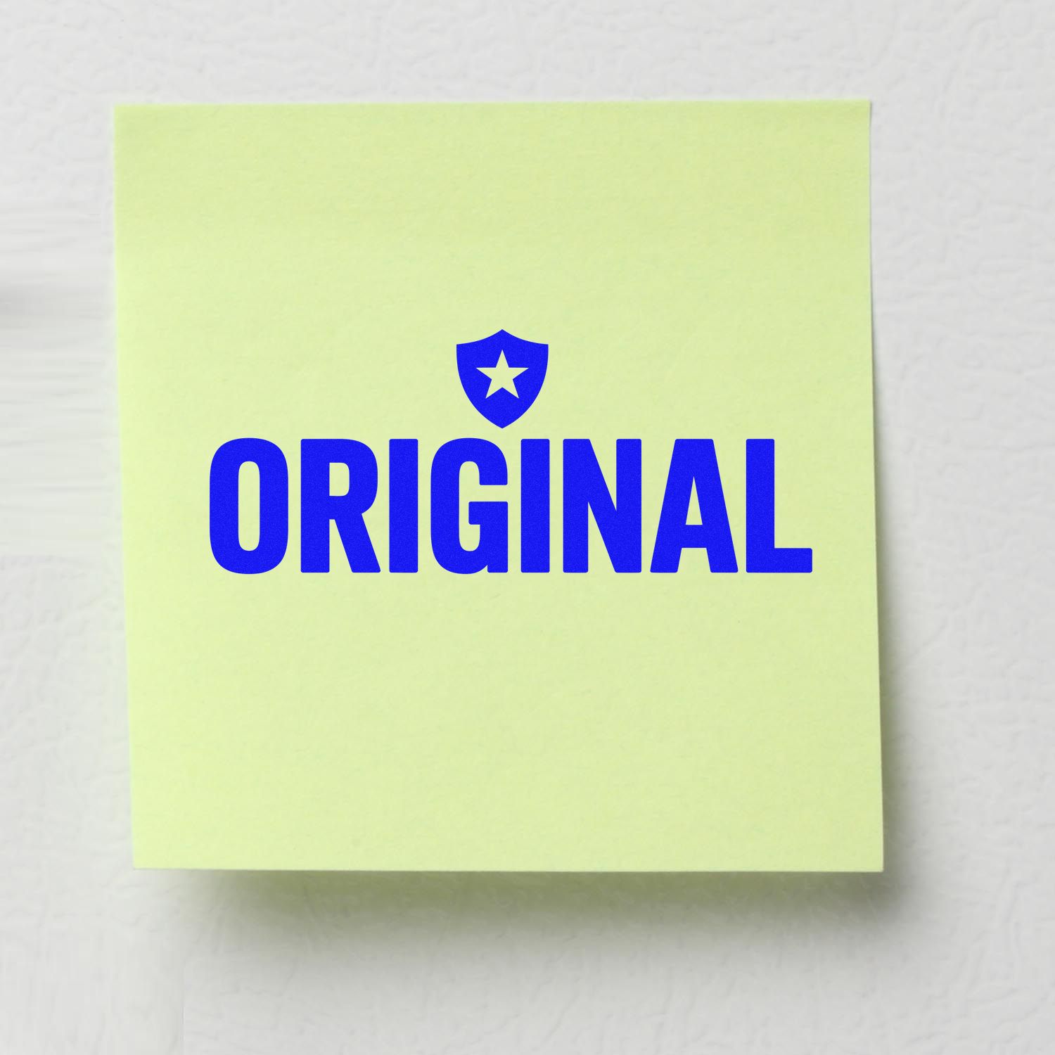 Original rubber stamp impression with shield icon on sticky note for authentic product marking and document verification.