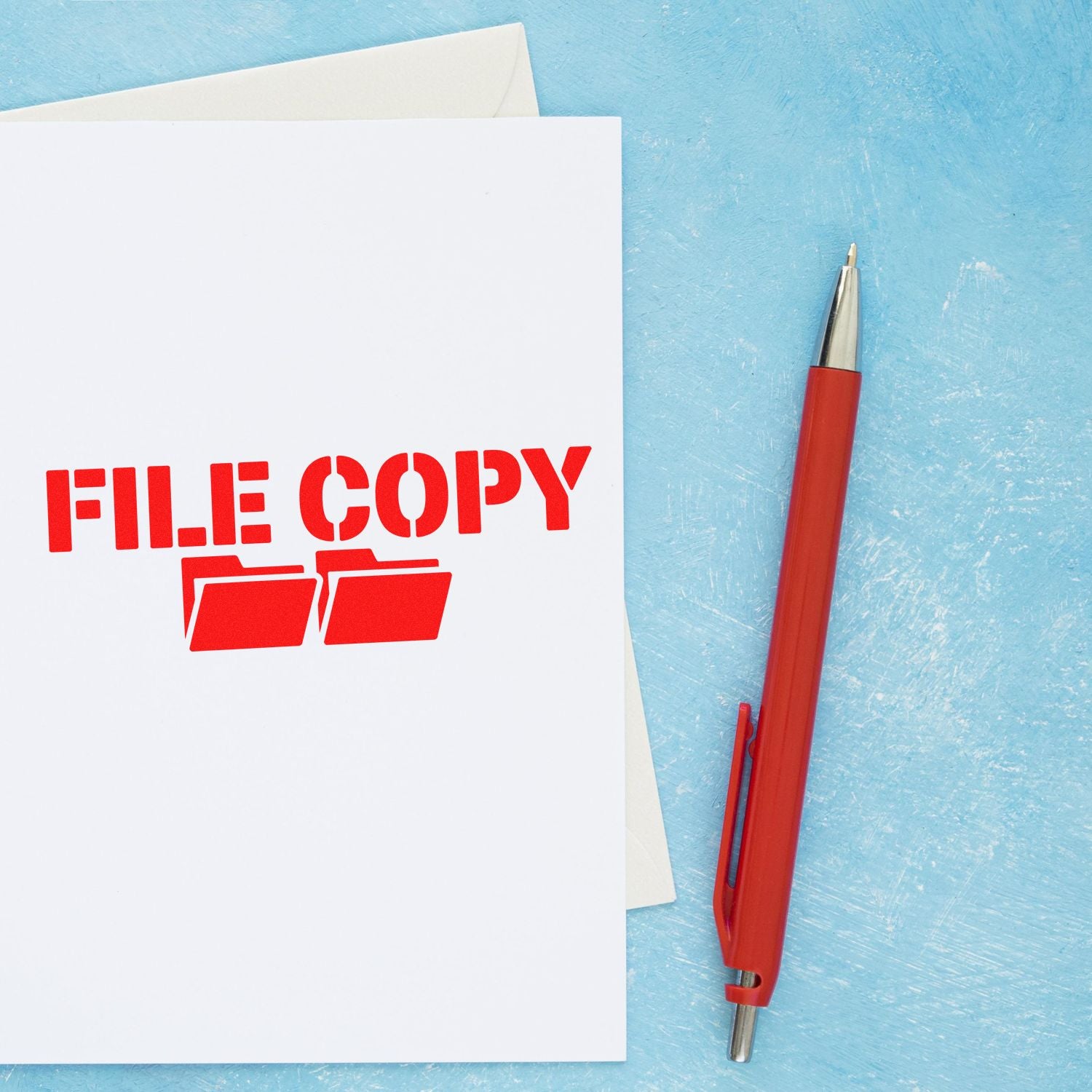 File Copy rubber stamp on document beside red pen, ideal for office paperwork organization and document filing.