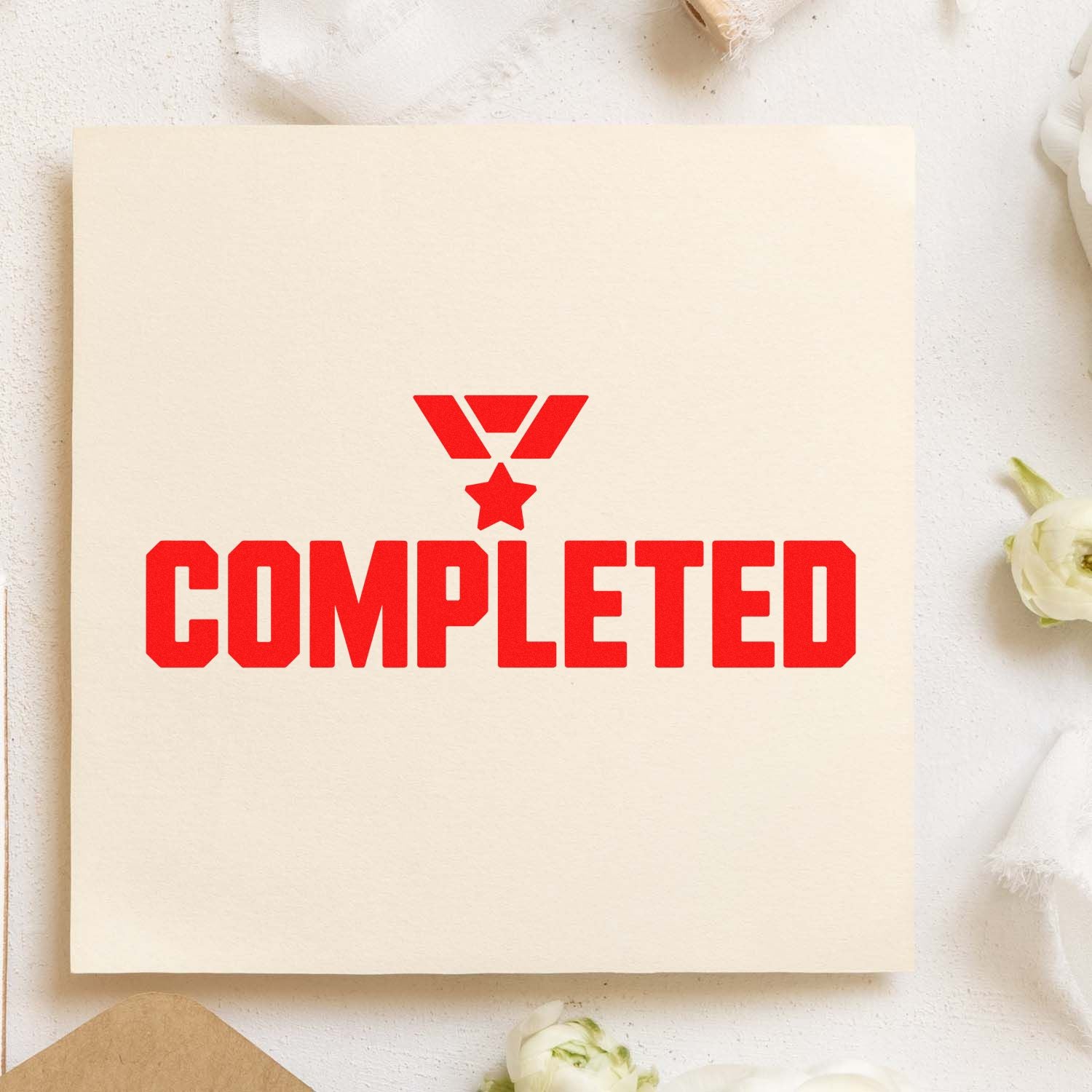 Completed rubber stamp design with red medal icon on cream paper card