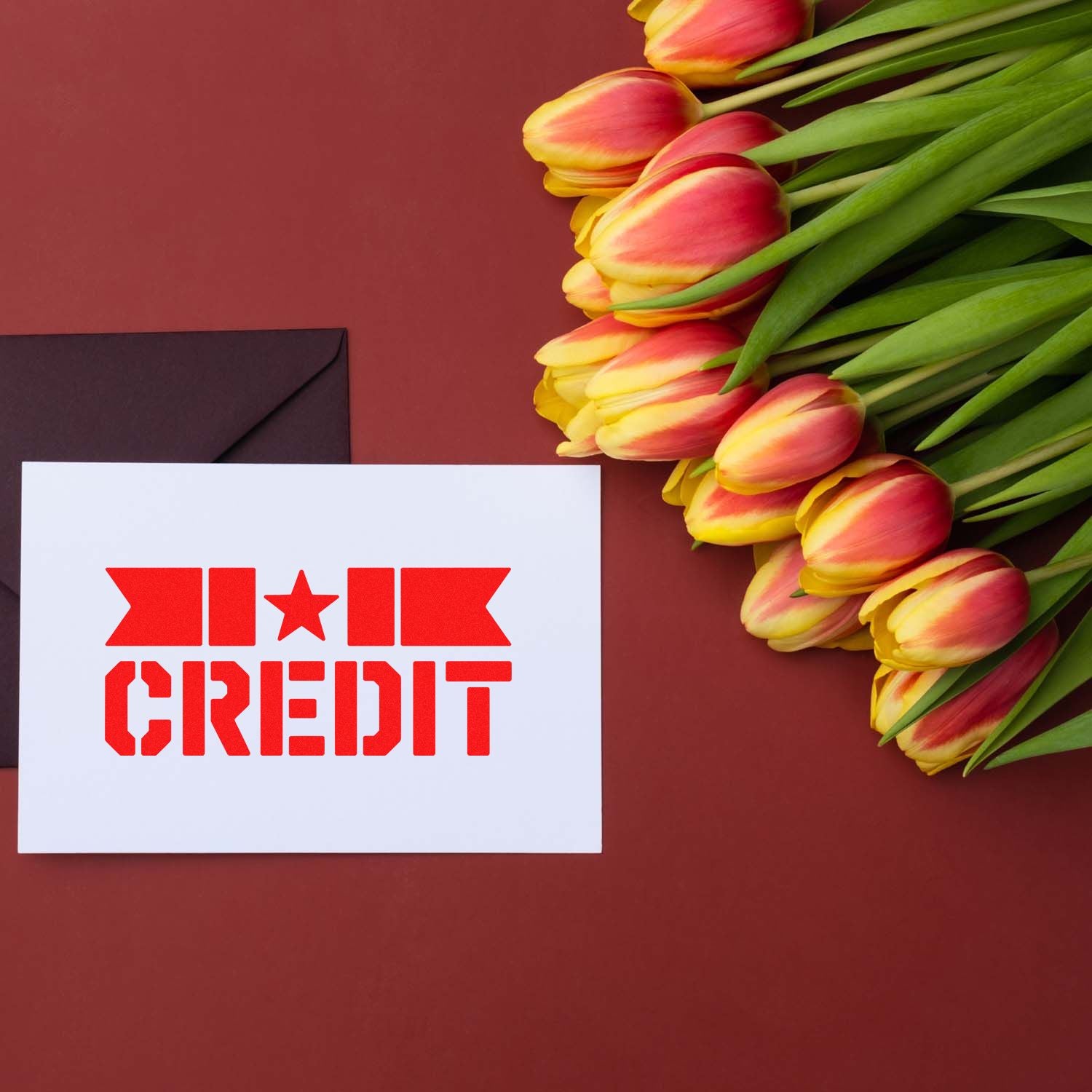 Red CREDIT rubber stamp on a card with tulips, ideal for custom stationery, business mail, or branding.