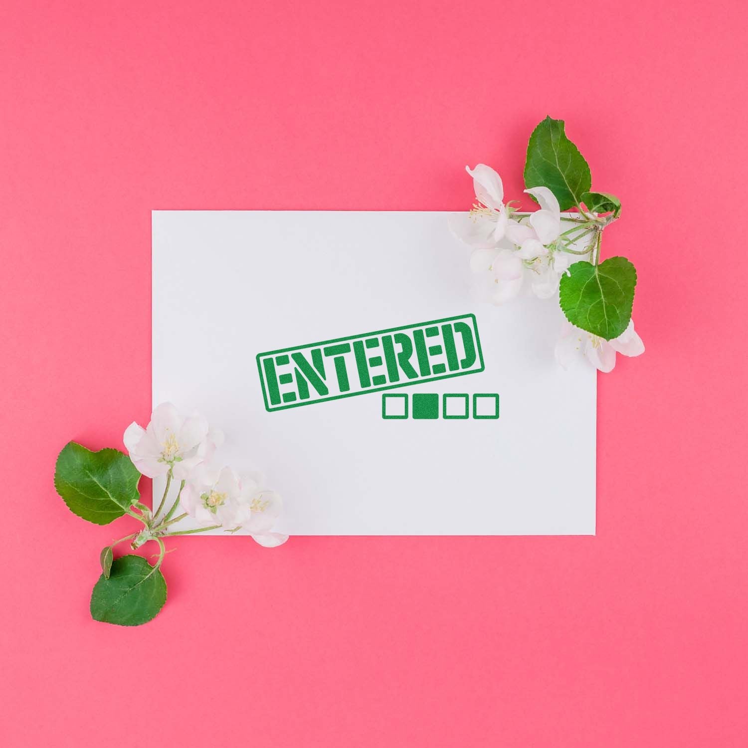 Green ENTERED rubber stamp impression on white card with flowers on a pink background