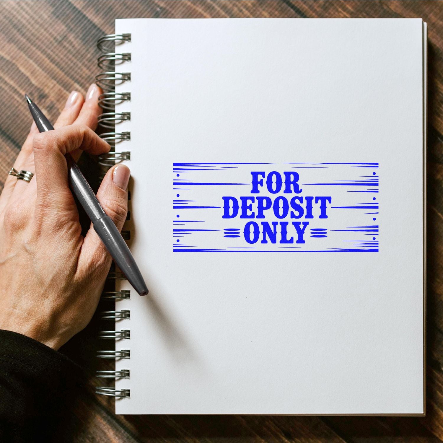 For Deposit Only rubber stamp imprint on notebook page, showing secure check endorsement stamp example.