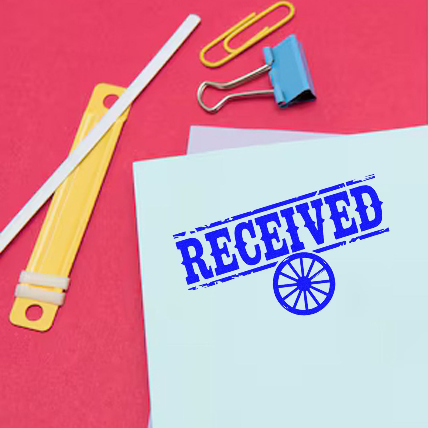 Received rubber stamp on paperwork with office supplies, ideal for marking incoming mail and office documents.