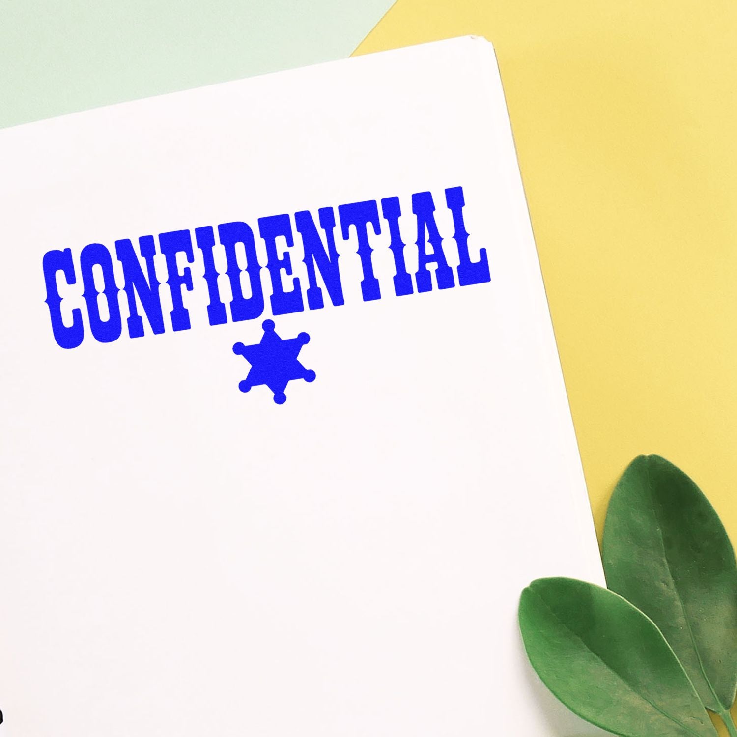 Confidential rubber stamp imprint on paper, blue office privacy seal with star icon for secure documents.