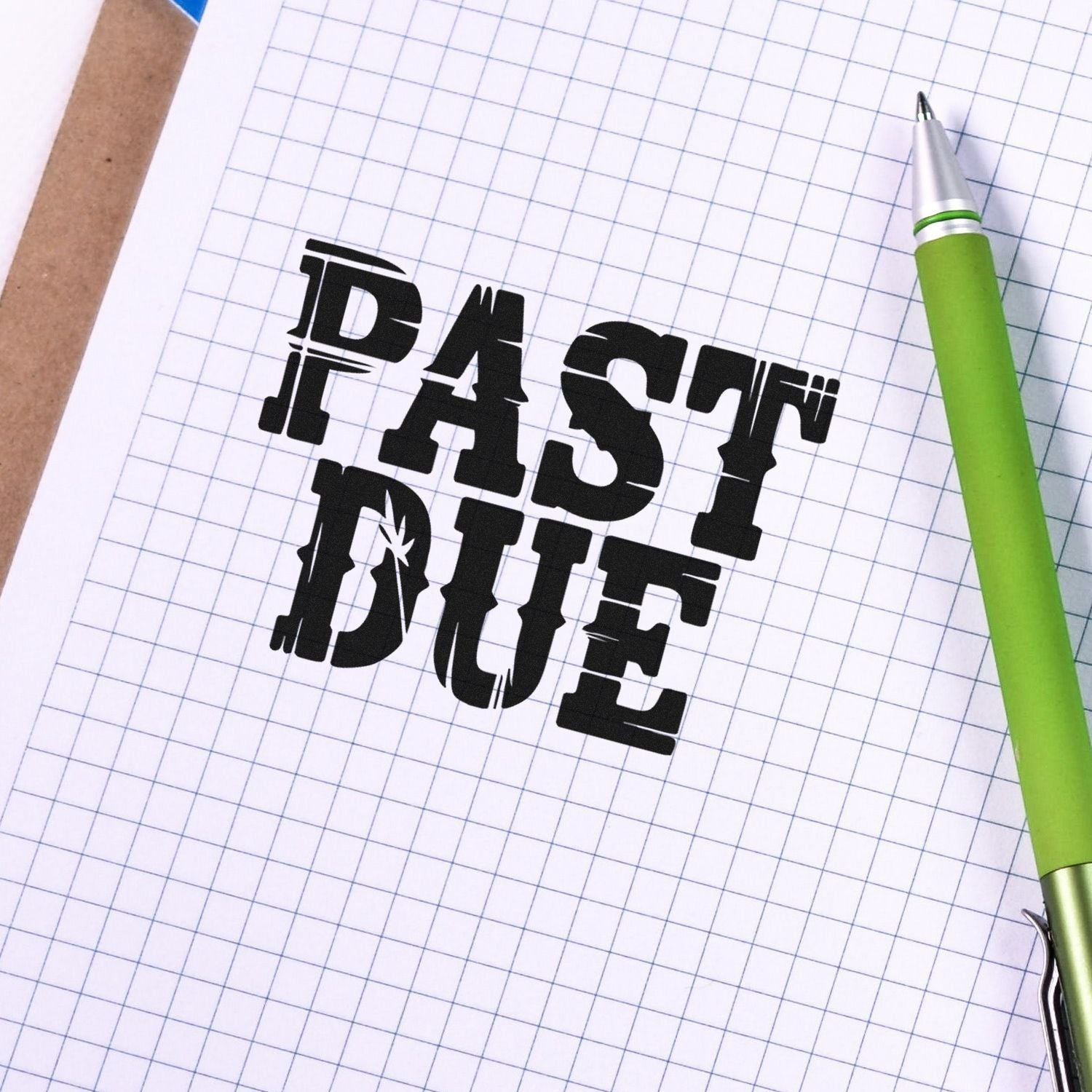 Past due rubber stamp on graph paper with green pen, ideal for overdue invoice reminders and office paperwork.