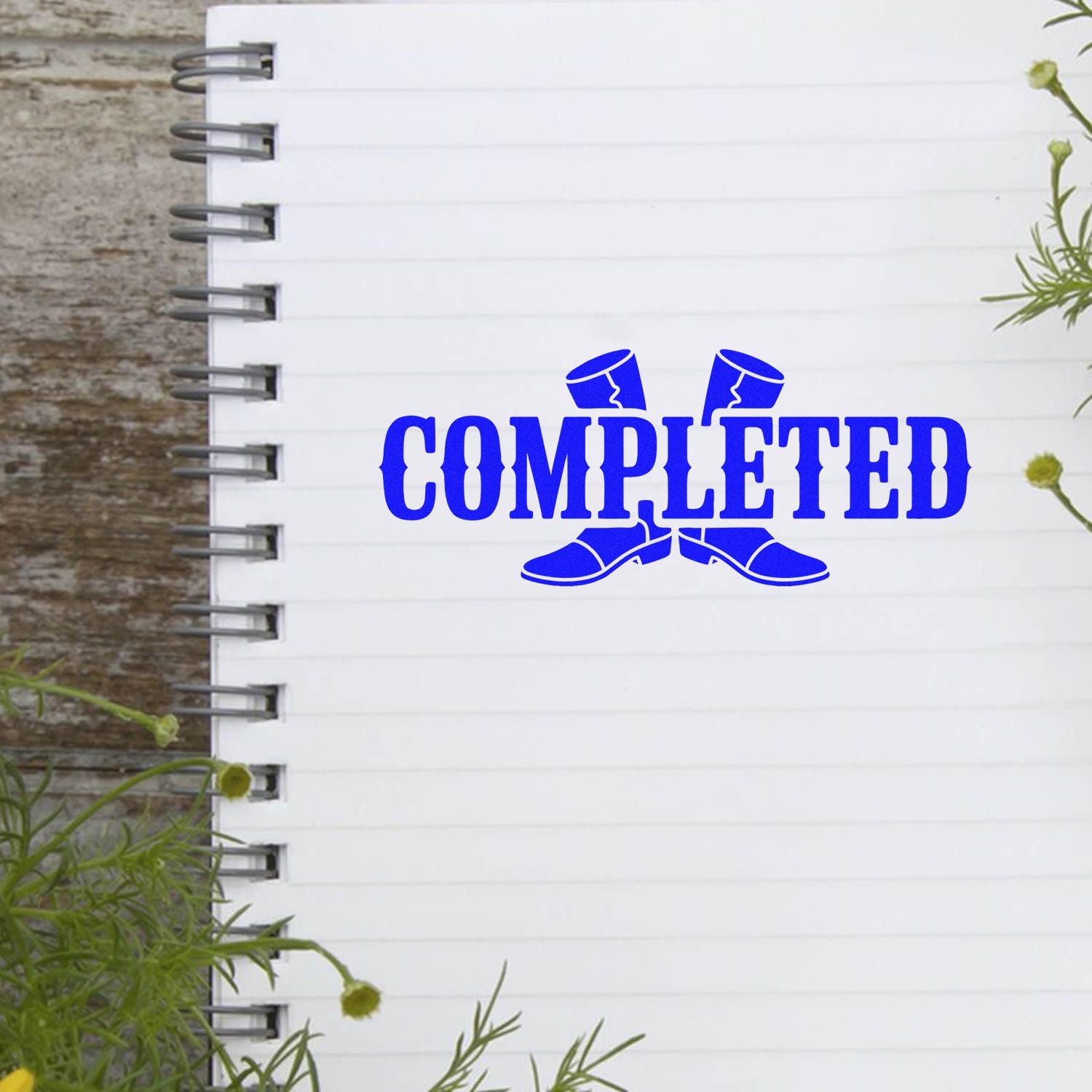 Blue Completed rubber stamp design on notebook paper, perfect for marking finished tasks, projects, or approvals.