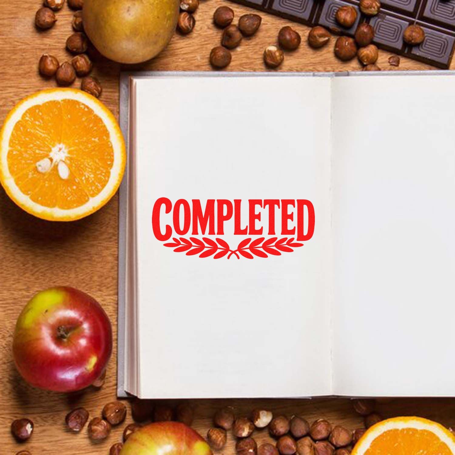Red COMPLETED rubber stamp on open notebook, ideal for planners, journals, and office approval marking.