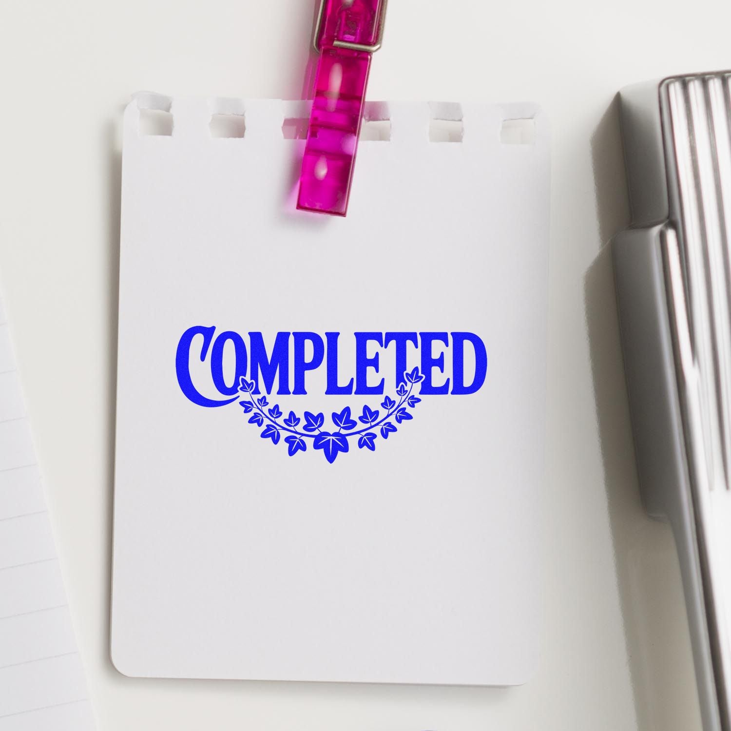 Custom rubber stamp impression reading COMPLETED on a notepad, marking finished paperwork or tasks.