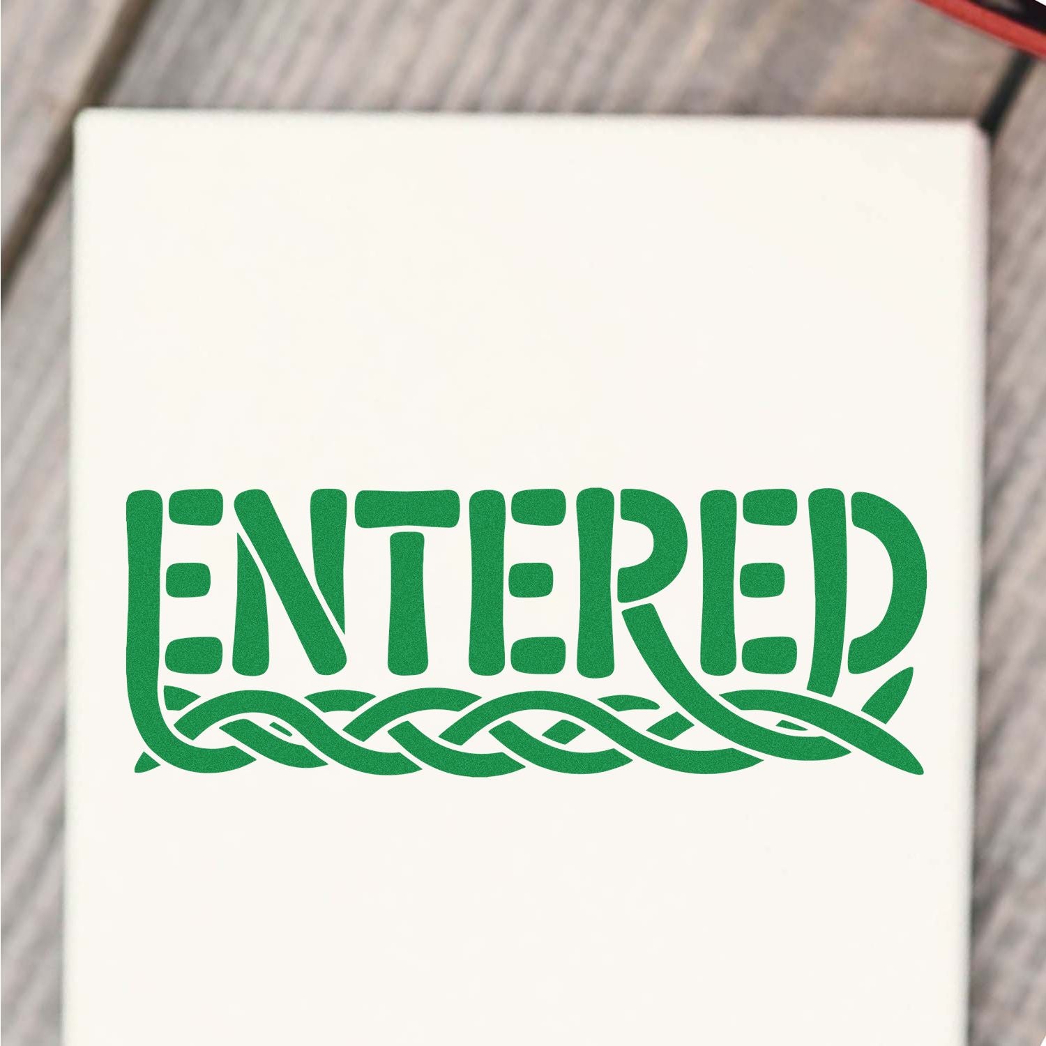 Green ENTERED rubber stamp impression on white paper for office approval, filing, and document processing.