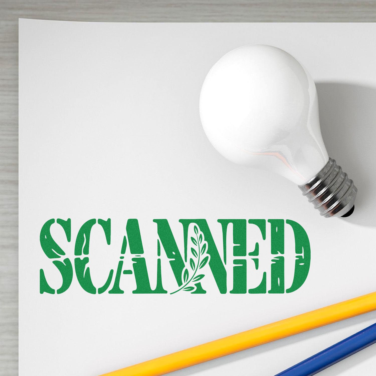 Custom rubber stamp mockup with bold green SCANNED text and leaf graphic on white paper, styled with pencil and light bulb.