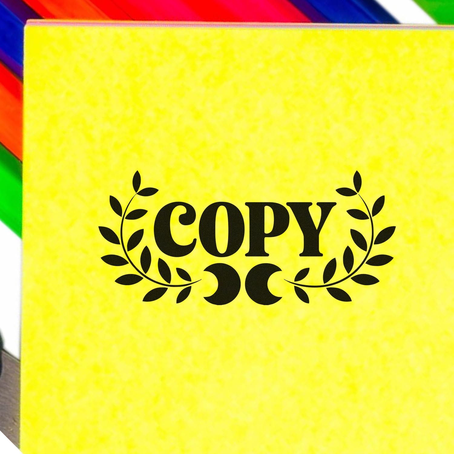 COPY rubber stamp with laurel leaves for office document marking on a yellow background.