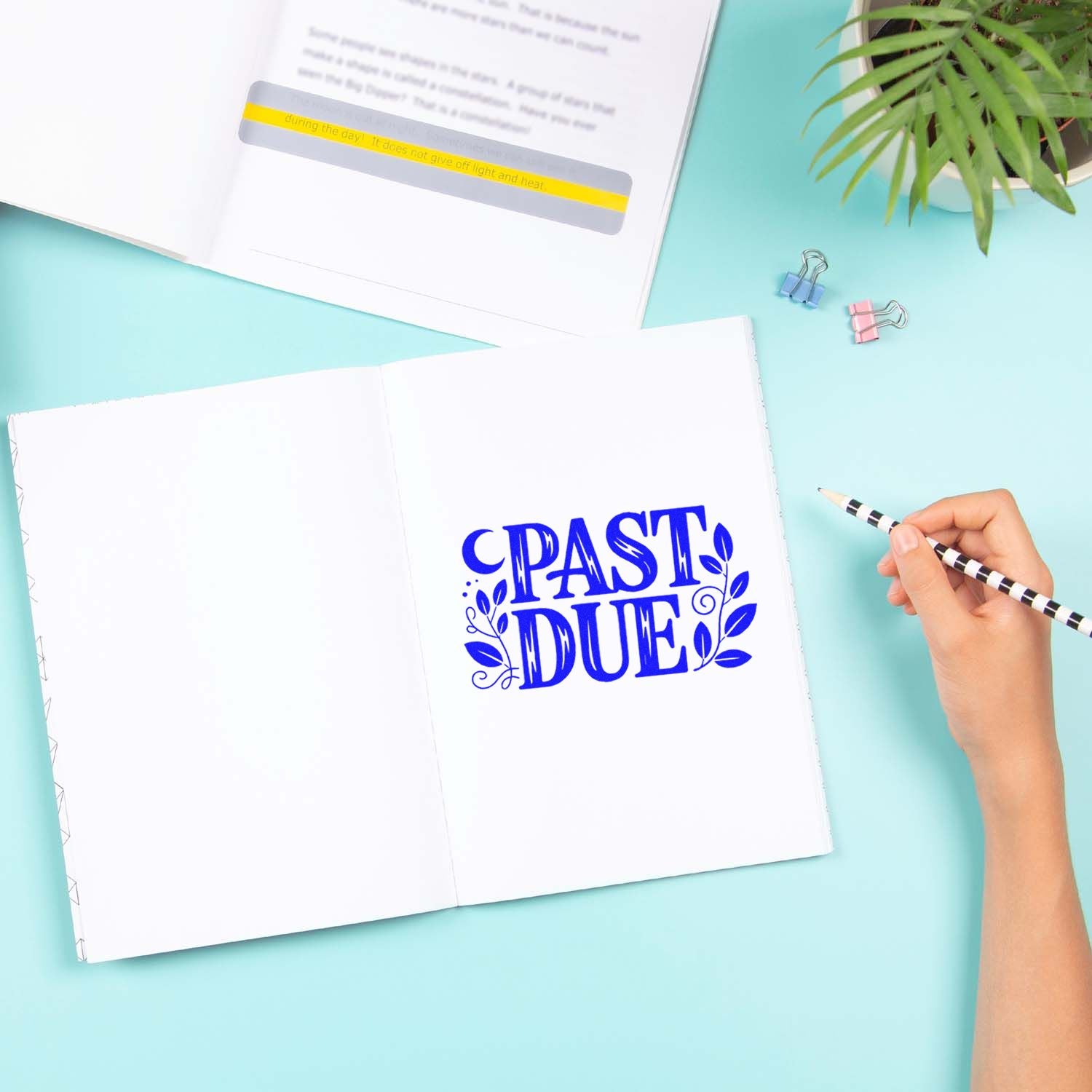 Past due rubber stamp graphic in an open notebook for deadline reminders and office organization