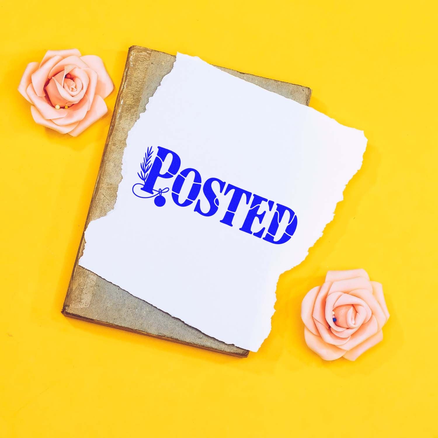 POSTED rubber stamp design on torn paper over a vintage book, styled with pink roses on a bright yellow background for mailing crafts.