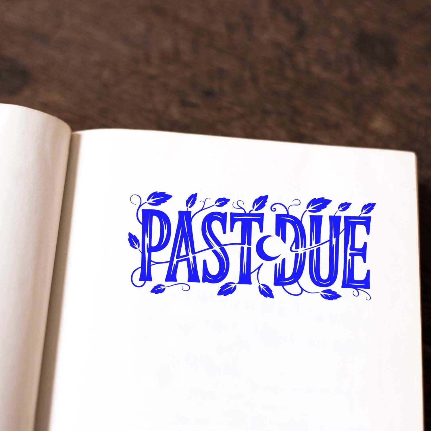 Decorative blue Past Due rubber stamp design on a notebook page for overdue reminders and office use.