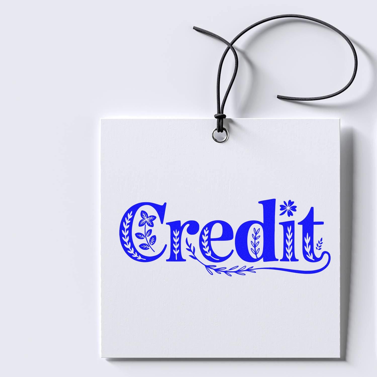 Blue decorative Credit rubber stamp impression on hanging white tag, ideal for custom branding and packaging.