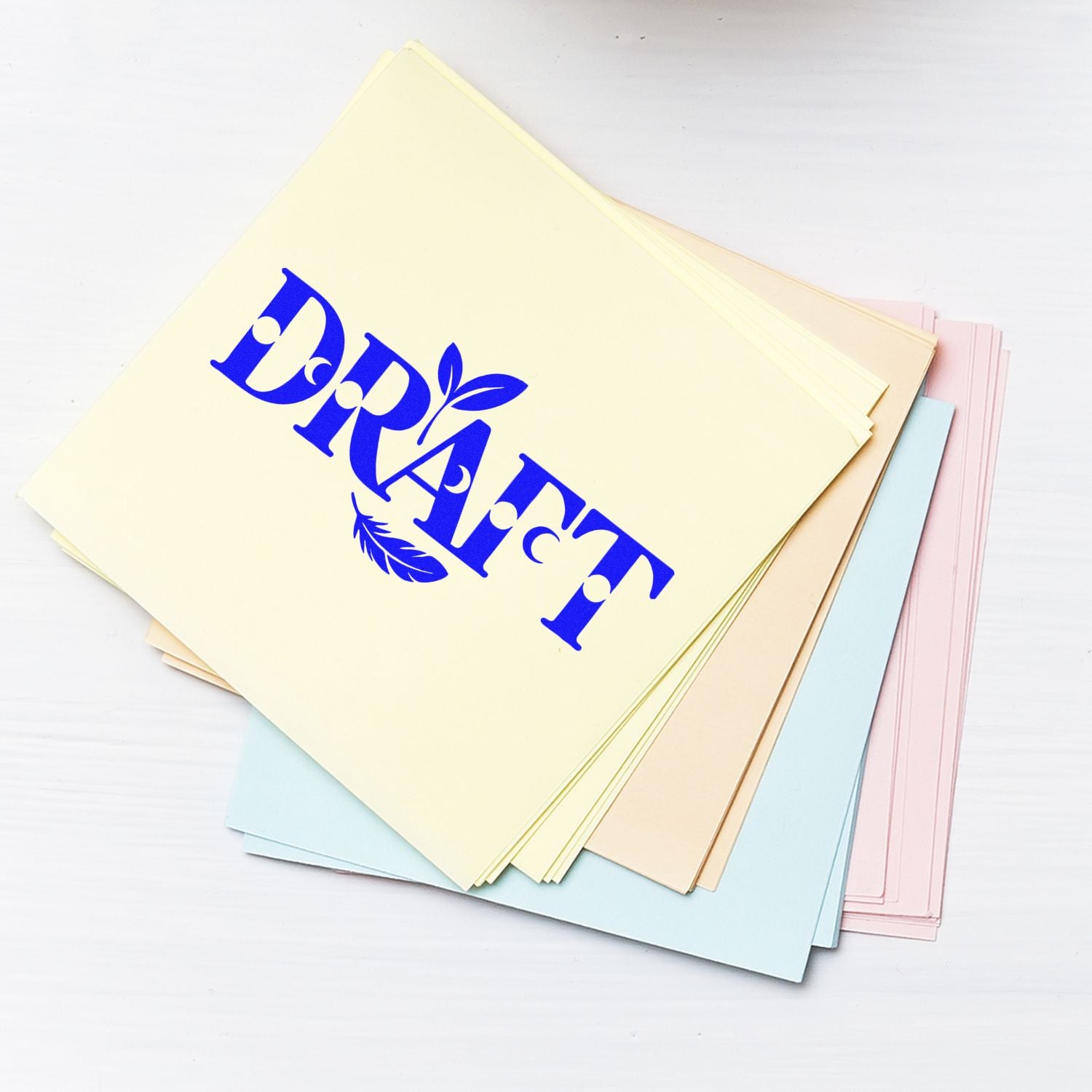 Draft rubber stamp impression on pastel cardstock sheets for office document approval and filing.