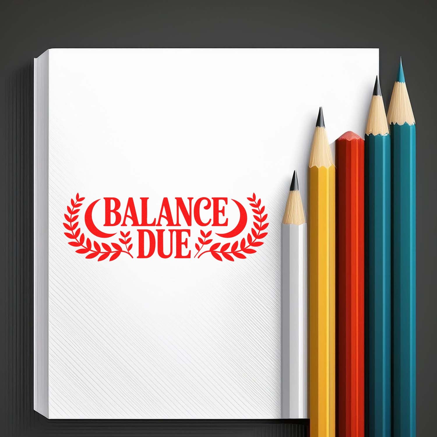 Red Balance Due rubber stamp on notepad beside colored pencils, ideal for accounting, billing, and office paperwork.