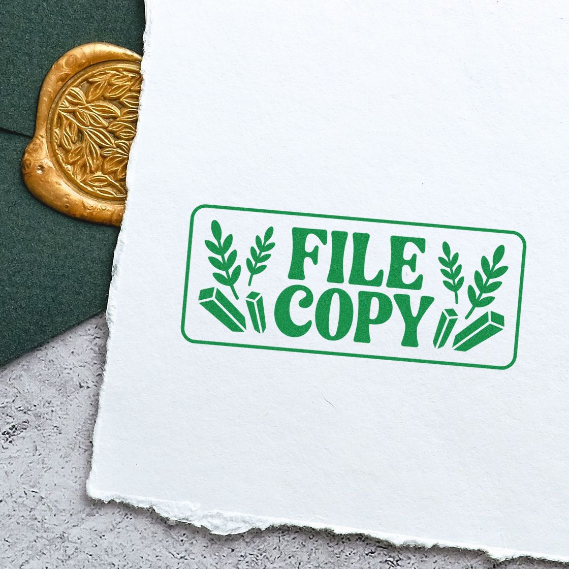 Green File Copy rubber stamp impression on paper for document filing, office records, and organized paperwork.