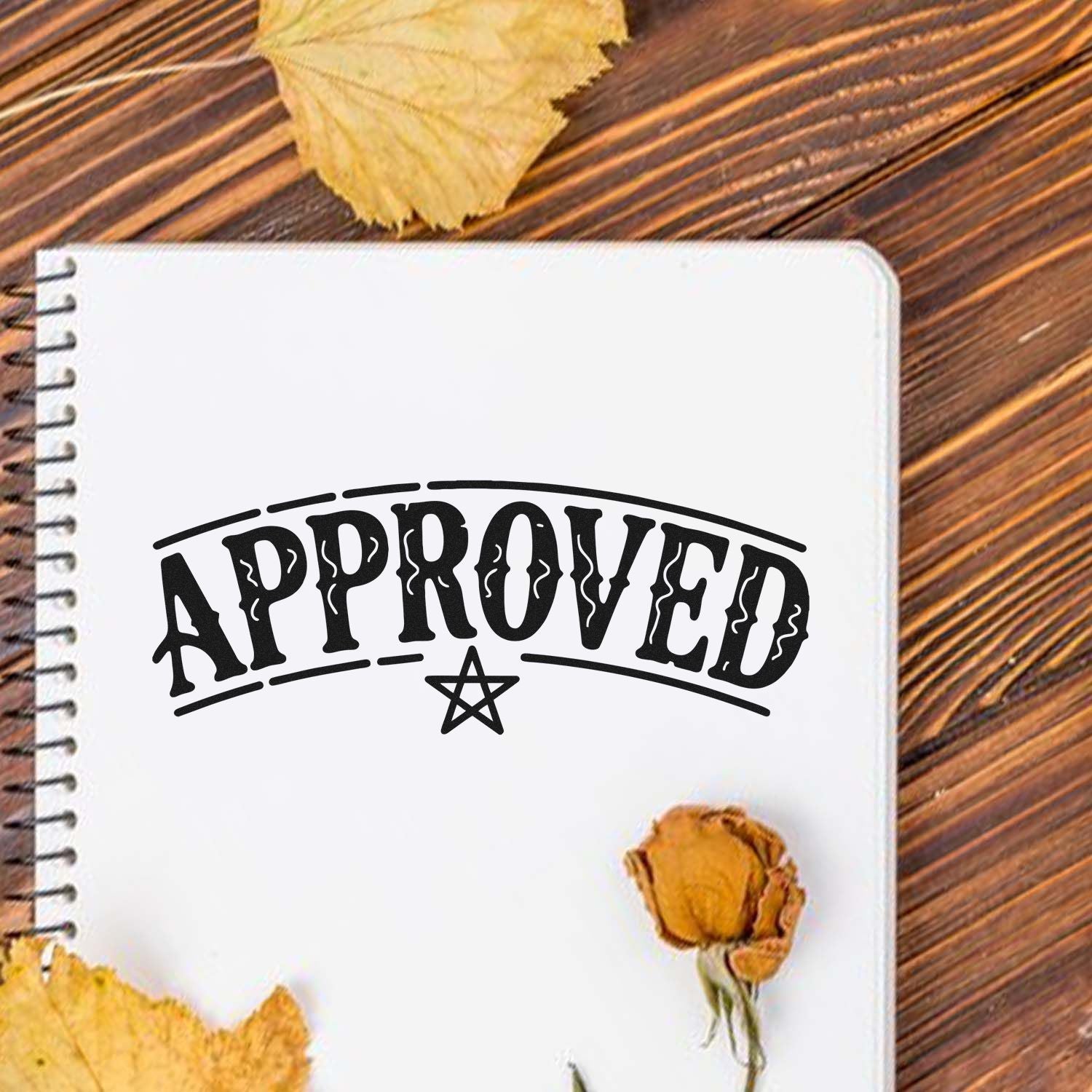 Approved rubber stamp design on notebook, vintage-style office approval stamp for custom branding and stationery.