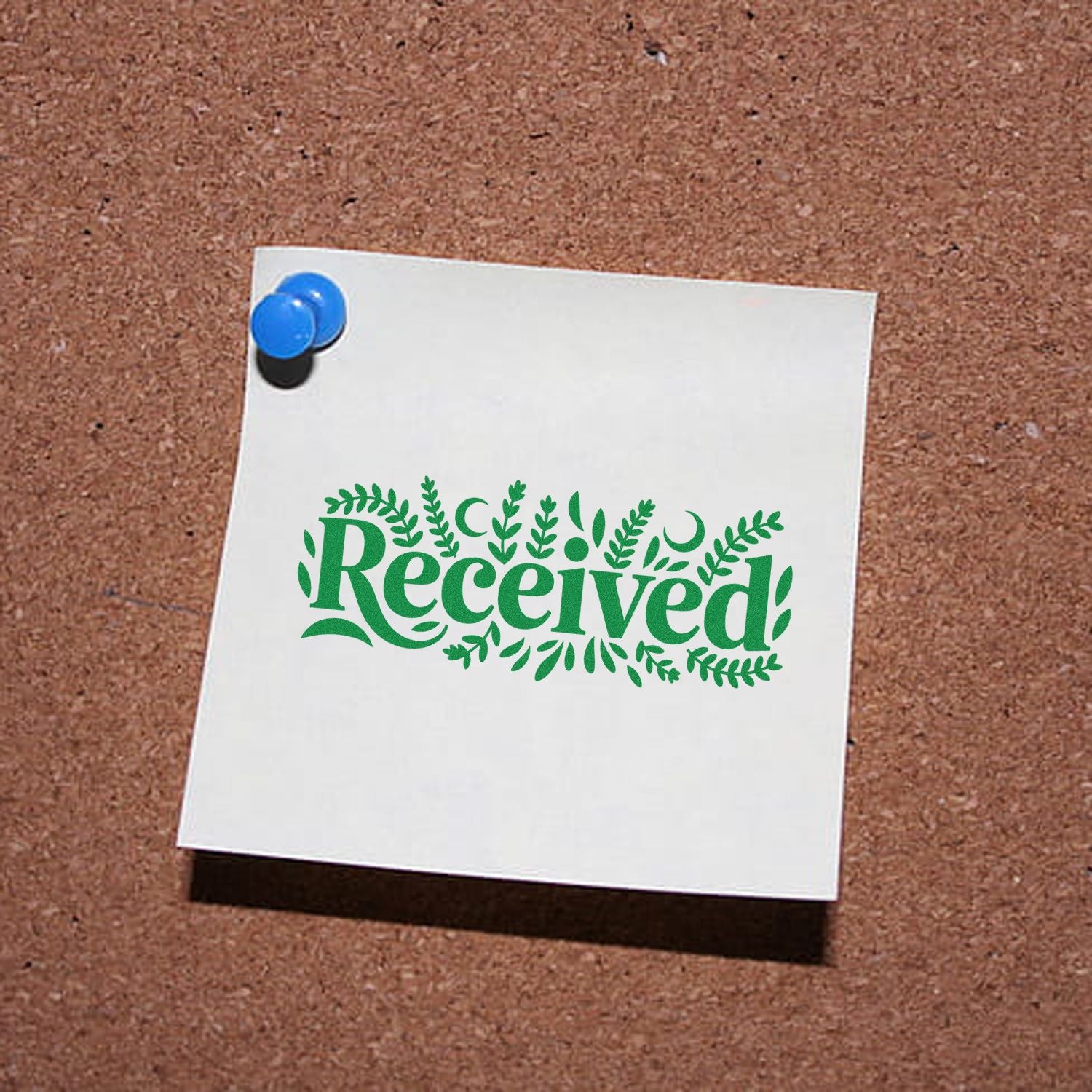 Decorative green Received rubber stamp design pinned on corkboard for office mail, document, and approval use.