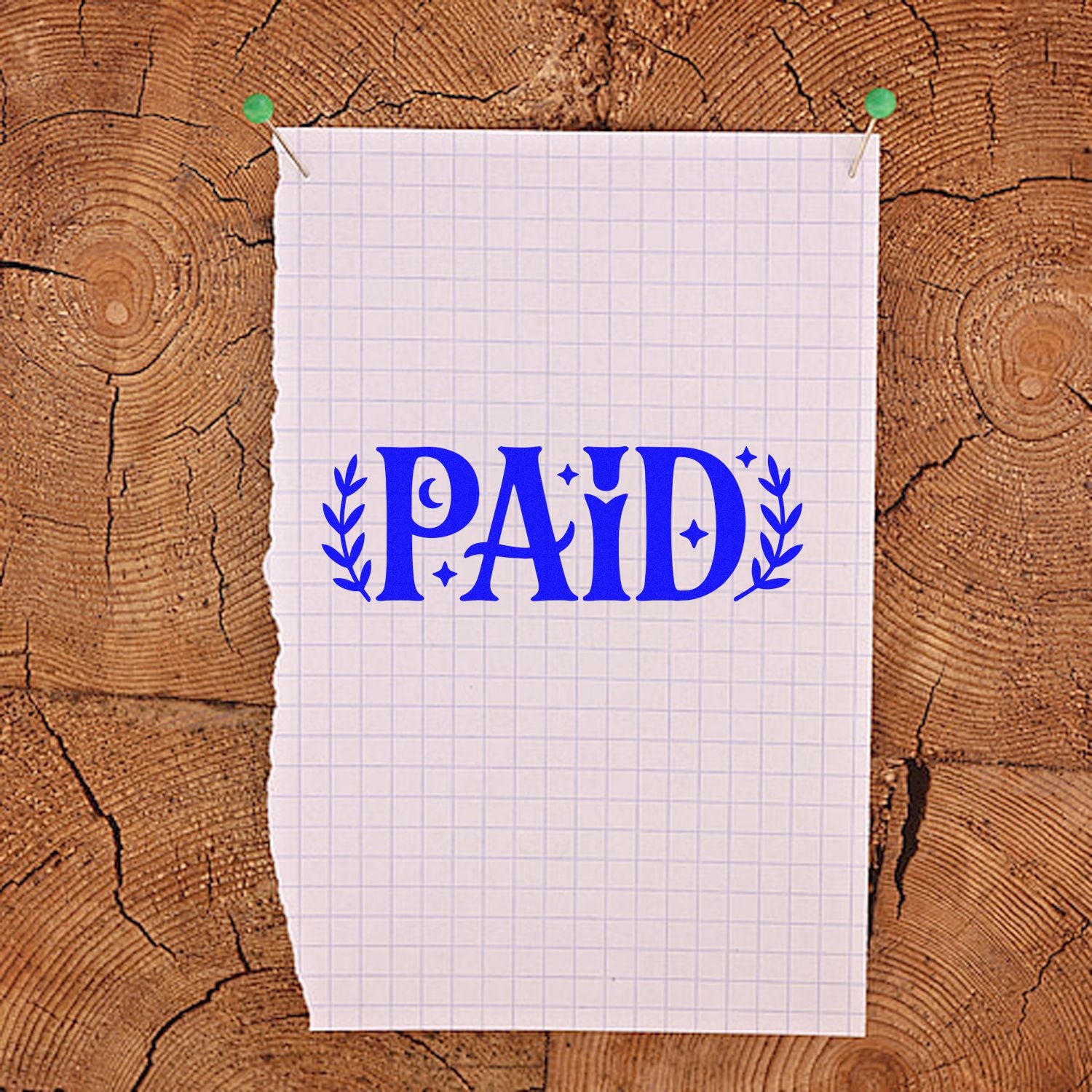Blue PAID rubber stamp design on pinned graph paper, ideal for invoice approval, receipts, and business payment marking.