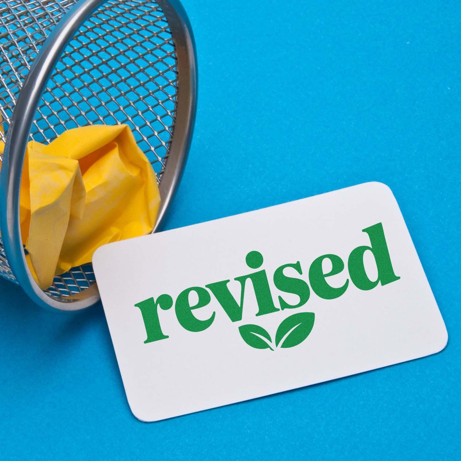 Revised rubber stamp for office documents, marking proofread forms and updated paperwork.