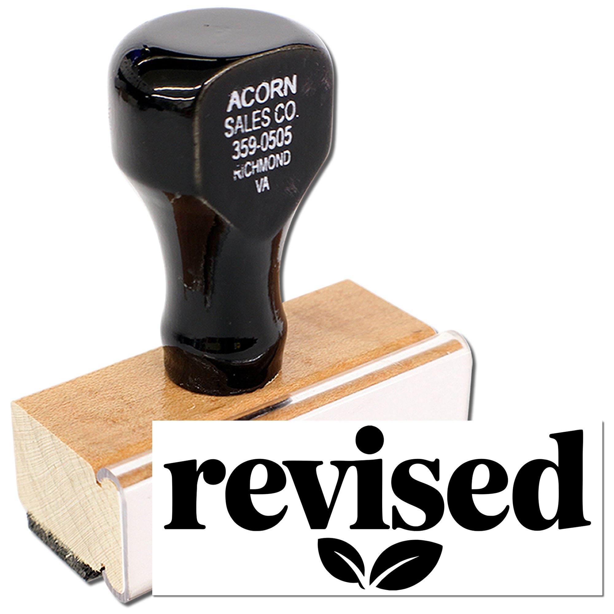 Revised rubber stamp with wooden handle for marking documents as updated or approved.