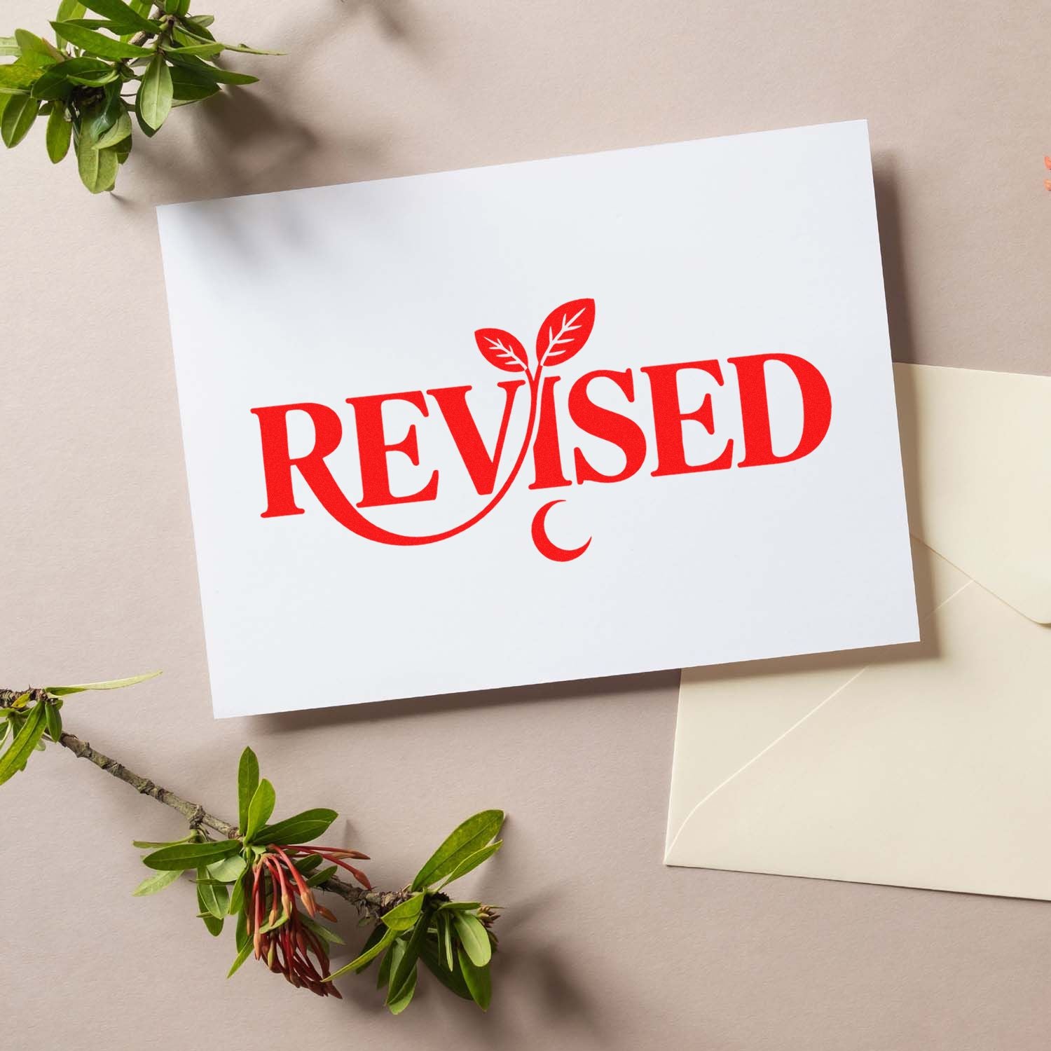 Red REVISED rubber stamp on white paper for document review, editing, and office paperwork.
