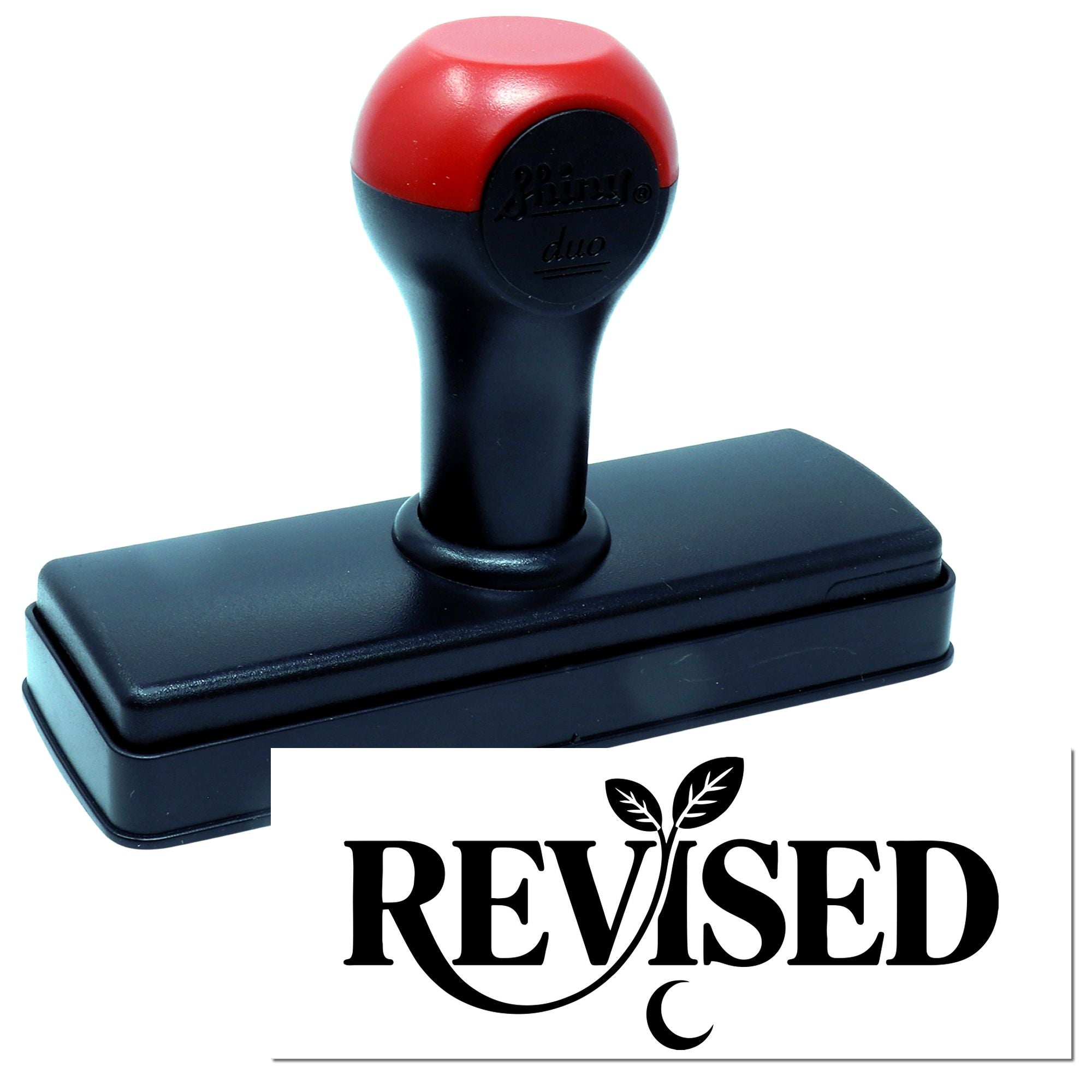 Self-inking rubber stamp with Revised imprint for office document approval and record marking.
