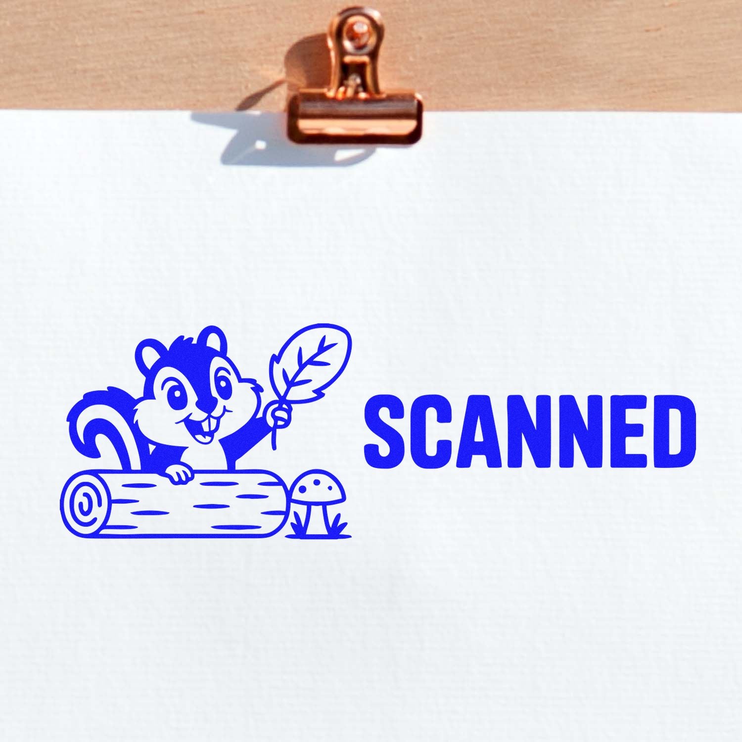 Blue scanned rubber stamp design with squirrel illustration and bold SCANNED text on white paper.