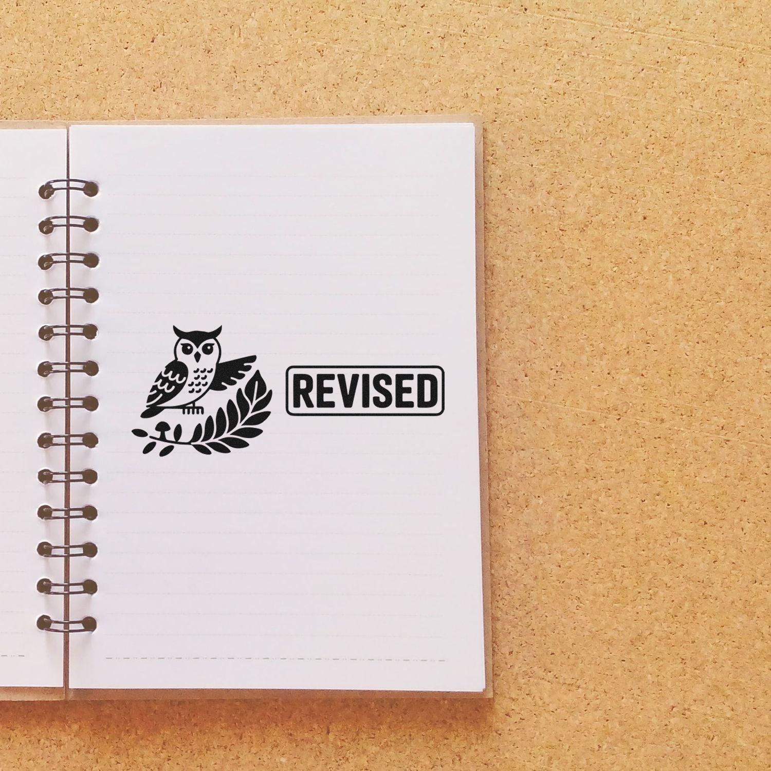 Owl revised rubber stamp on notebook page for marking edited documents, notes, and schoolwork.
